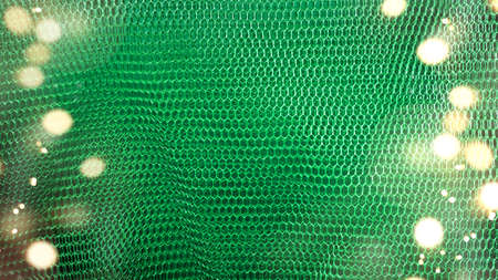 Blurred abstract Christmas Green background with defocused lights and copy space. High quality photo