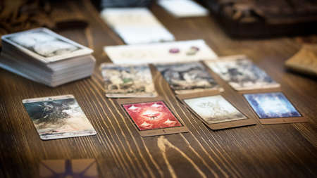 Tarot card reader arranges cards in a card spread. Fortune-telling on traditional tarot cards on the table. Selective focus, Moscow, Russia-June 2021.のeditorial素材