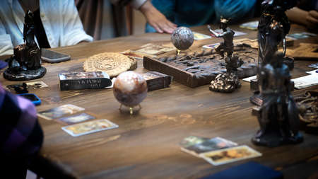 Tarot card reader arranges cards in a card spread. Fortune-telling on traditional tarot cards on the...