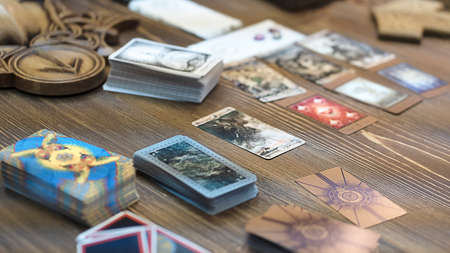 Tarot card reader arranges cards in a card spread. Fortune-telling on traditional tarot cards on the table. Selective focus, Moscow, Russia-June 2021.のeditorial素材