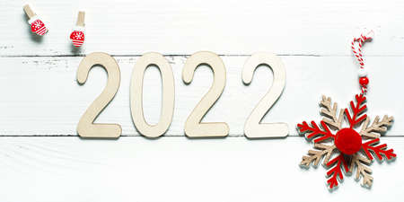 Wooden 2022 numbers on White background. Minimal concept of Xmas and New Year. High quality photo
