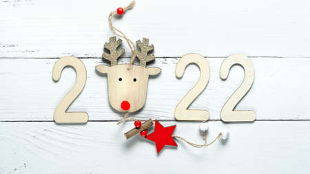 Wooden 2022 numbers on White background. Minimal concept of Xmas and New Year. High quality photo