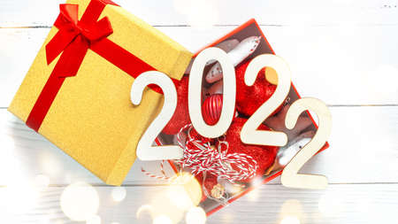 Minimal concept of Xmas and New Year. Christmas composition of present in Golden box on White...