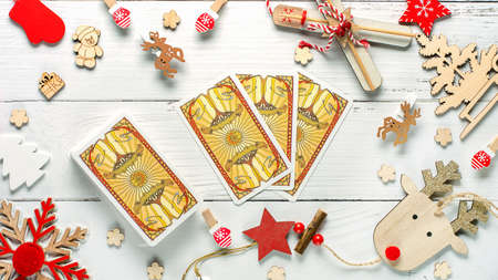 Christmas composition made of Christmas decoration and 2022 numbers and Tarot cards on White background. Esoteric concept, fortune telling and predictions, Moscow, Russia - October 2021. High quality photoのeditorial素材