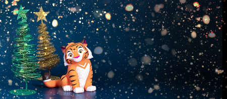 Banner for Christmas and New Year Christmas tree, snowflakes, on blue background, tiger symbol Chinese zodiac calendar. High quality photoの写真素材