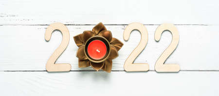 Wooden 2022 numbers on White background. Creative concept of Xmas and New Year. High quality photo