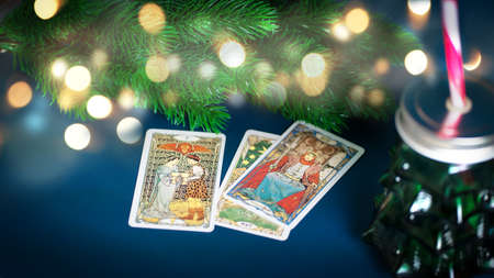 Tarot cards in Christmas decoration. Esoteric concept, fortune telling and predictions, Moscow, Russia-July 2021. High quality photoのeditorial素材