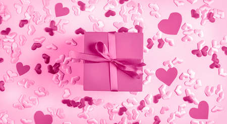 Valentine's Day background. pink present gift box on pink background with hearts. The concept of gifts relationships holidays Valentines day. Flat lay, top view.の写真素材