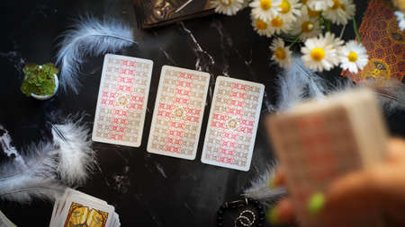 Woman makes a forecast of fate Tarot cards, Fortune telling esoteric tarot predictions background,...