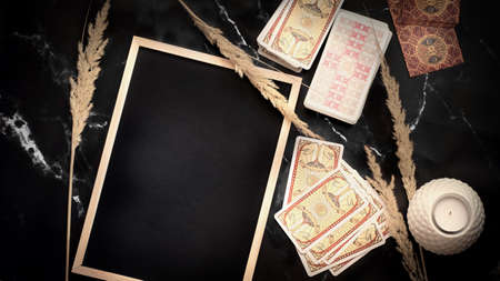 Blurred predictions background. Tarot cards layout on witch table. Esoteric concept and astrology,...