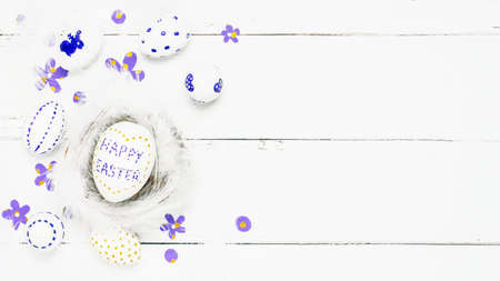 Colorful background with Easter eggs on white wooden board background. Happy Easter concept. Can be used as poster, background, holiday card.の写真素材