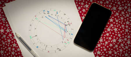 Cartomancy and fortune telling concept. Natal chart smartphone with Black screen tarot cards. high quality photoのeditorial素材