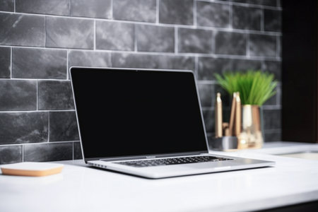 Close up of modern workplace with blank laptop screen, coffee cup and other items. Mock upの素材
