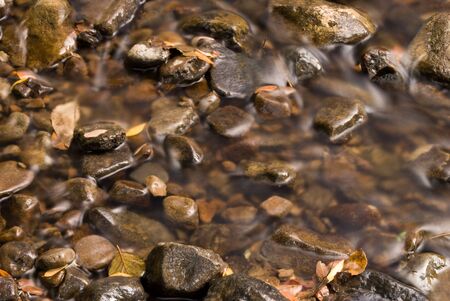 Big and small river's stones in mountain's streamの写真素材