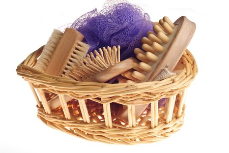 Bath anti-cellulitis spa massage kit with comb, brush, sponge and hairbrush in basket isolated on white background の写真素材