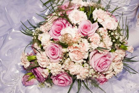 Bride hold the bouquet from pink roses and carnationsの写真素材