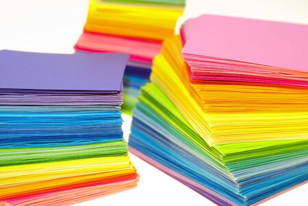 various color paper stack like a rainbow isolated on white. shallow deep of field