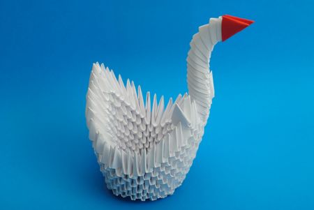 Origami swan isolated on blue background like waterの写真素材