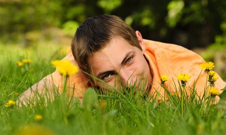 Man lie on the grass. Shallow DOF. Outdoor portraitの写真素材