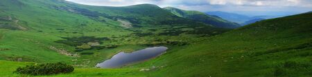 Beautiful blue sky and rock high up in Carpathian mountains. Lake "Nesamovyte" panoramaの写真素材