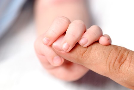 Little hand of son hold father's finger