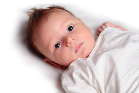 Baby boy lie on white diaper and lookの写真素材