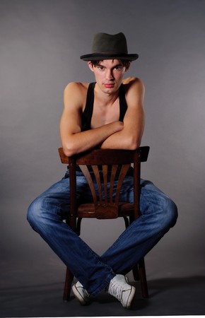 Man sitting on chair and lower his head in hatの写真素材