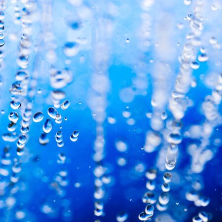 water drops over blue background with copy spaceの写真素材
