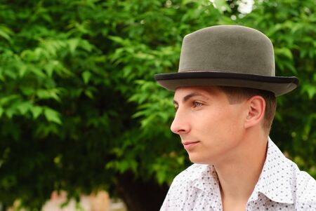 Man in felt hat outdoor, close up face, profile portraitの写真素材