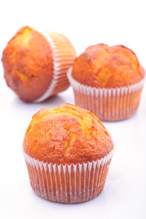 Three fresh muffins isolated on white backgroundの写真素材