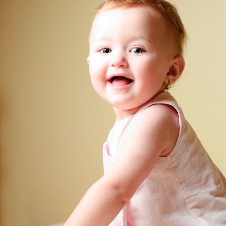 Happy little girl look with staring eyes and smile.