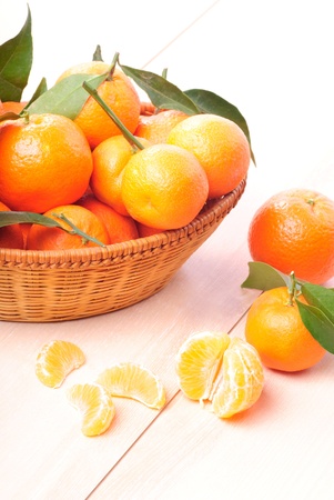 tangerines in basket on the kitchen's wooden tableの写真素材