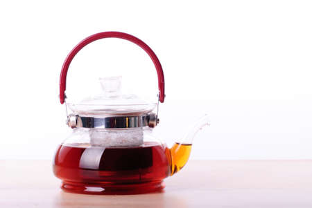 Teapot on wooden table, isolated on whiteの写真素材