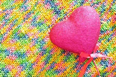 Rainbow knited texture with pink heart close upの写真素材