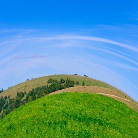 Beautiful blue sky and dry grass and view on the village in Carpathian mountains