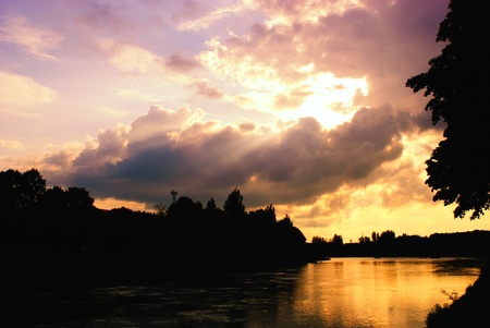 Sunset on the river and tree's silhouetteの写真素材
