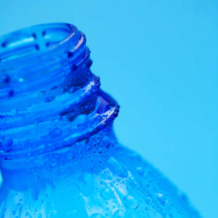 bottleneck with cold mineral water over blue. Selecrive focusの写真素材
