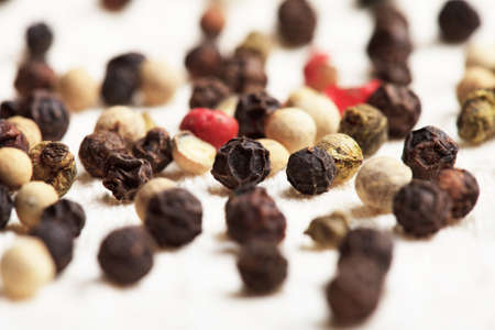 Different peppercorns on white napkin close upの写真素材