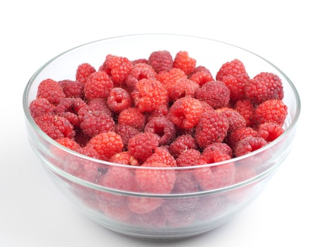 Raspberries in bowl isolated on white backgroundの写真素材