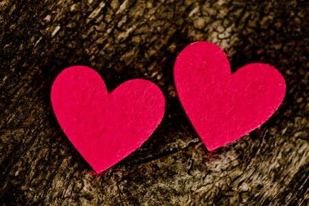 Red hearts stickers on wooden background の写真素材
