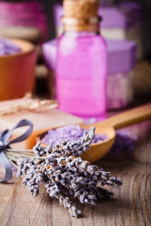 Lavender treatment soap, sea salt and essential oil on wooden tableの写真素材