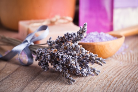 Lavender treatment soap, sea salt and essential oil on wooden tableの写真素材