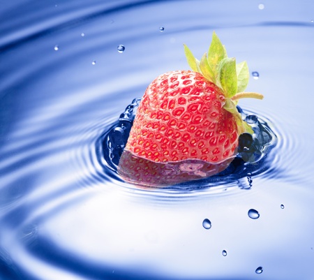 Blue water drop closeup with strawberry incideの写真素材