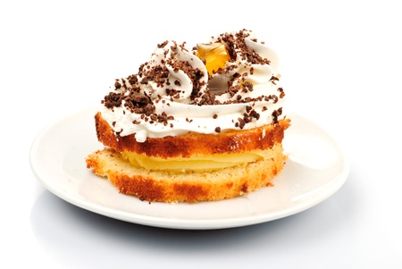 Sponge cake with custard and whipped cream isolatedの写真素材