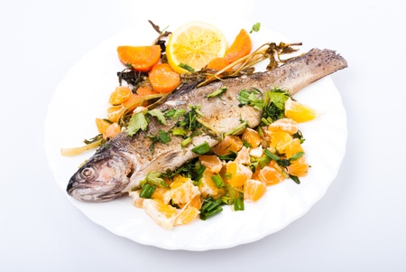 Roasted trout with vegetables and herbsの写真素材