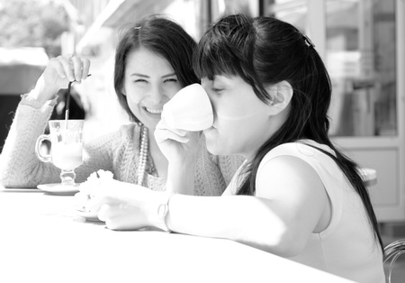 Coffee time in outdoor cafe. Black and white