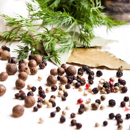 Different peppercorns on white napkin closeup