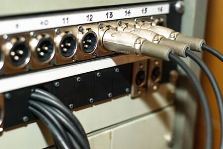 Video and sound cables on telestudio in plugs, blue tonedの写真素材