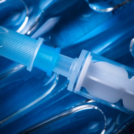 Injection with vaccine closeup on blue backgroundの写真素材