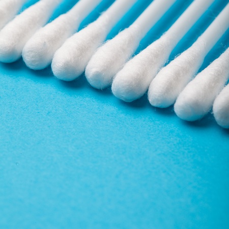 White cotton ear sticks on blue background macroの写真素材